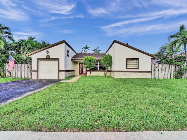 view of front of house with a garage and a front lawn