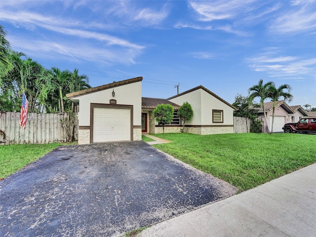 view of front of property featuring a garage and a front yard