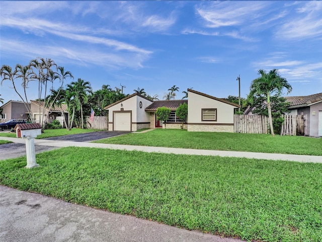 view of front facade with a garage and a front lawn