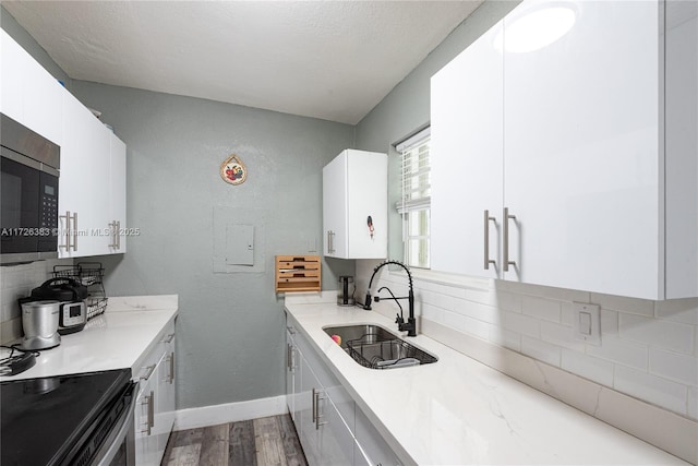 kitchen with sink, white cabinets, and decorative backsplash