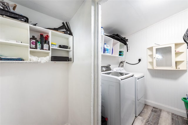 washroom with washing machine and dryer and light hardwood / wood-style floors