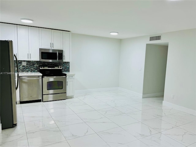 kitchen with white cabinetry, tasteful backsplash, and appliances with stainless steel finishes