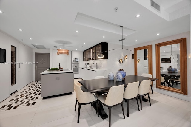 tiled dining room featuring sink