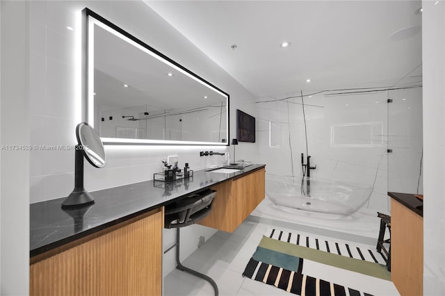 bathroom featuring an enclosed shower, vanity, and tile patterned floors