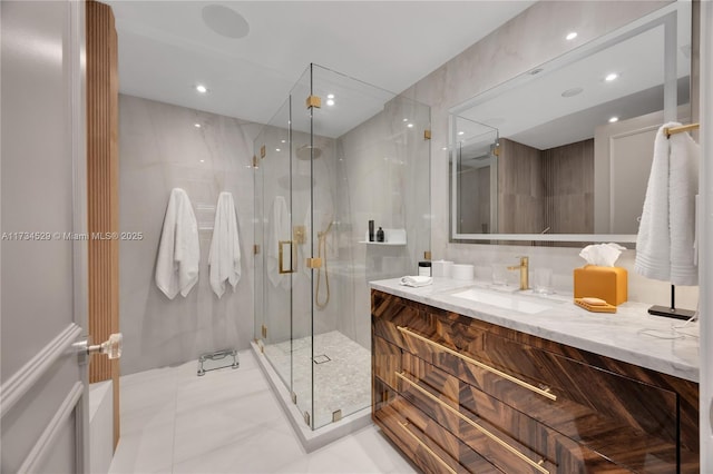 bathroom with vanity, an enclosed shower, and tile patterned floors