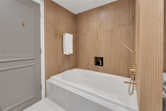 bathroom with a relaxing tiled tub