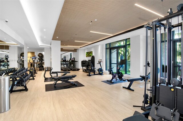 3400 SW 27th Ave Unit 704, Miami, FL 33133 - exercise room with wood finished floors and a wall of windows