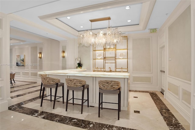 bar featuring pendant lighting, crown molding, and a raised ceiling