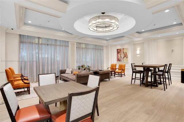 3400 SW 27th Ave Unit 704, Miami, FL 33133 - dining space with ornamental molding, light wood finished floors, a chandelier, and a raised ceiling