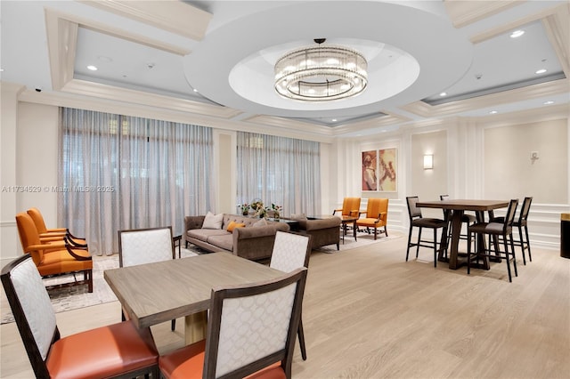 dining area with an inviting chandelier, coffered ceiling, crown molding, and light wood-type flooring