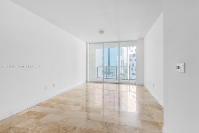 spare room featuring expansive windows