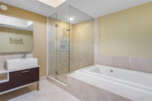 bathroom featuring vanity and separate shower and tub