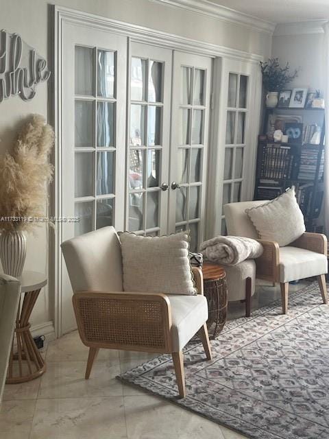 living area with ornamental molding and french doors