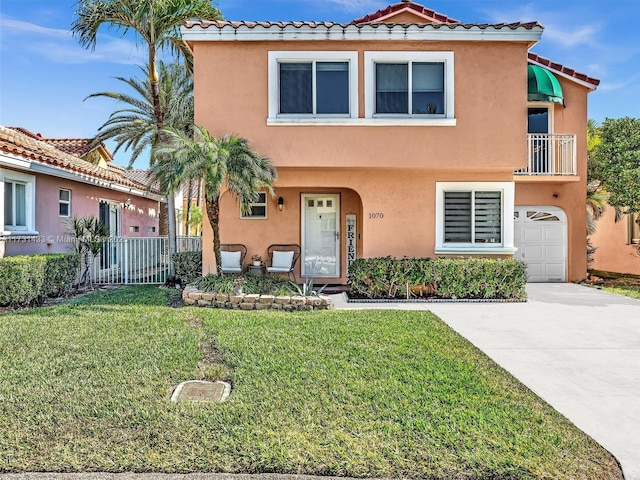 mediterranean / spanish house featuring a garage and a front yard