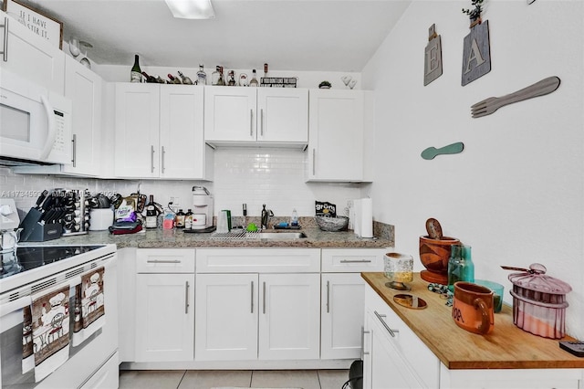 kitchen featuring white cabinetry and white appliances