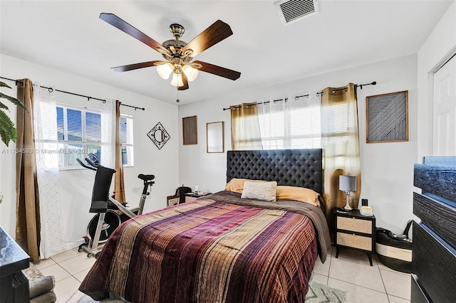 tiled bedroom with multiple windows and ceiling fan