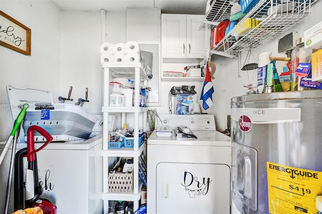 washroom featuring independent washer and dryer, cabinets, and water heater