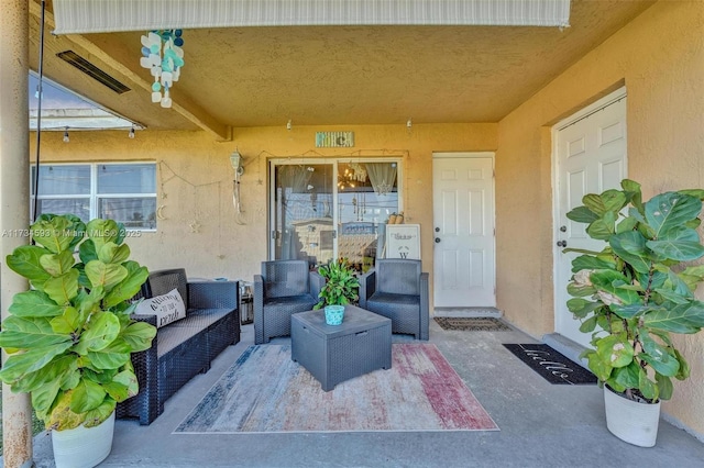 doorway to property featuring an outdoor hangout area and a patio