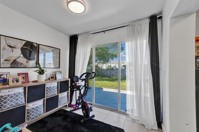 exercise room with light tile patterned floors