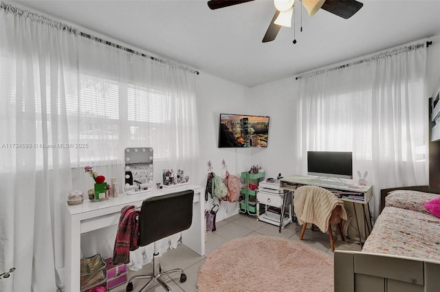 office with light tile patterned floors and ceiling fan