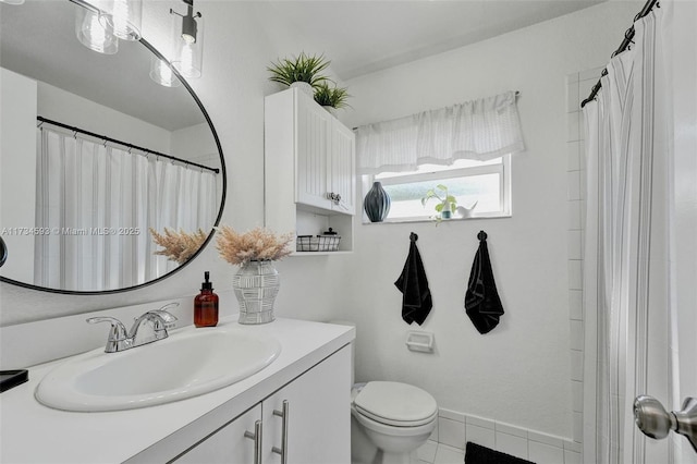 bathroom featuring vanity, tile patterned floors, and toilet