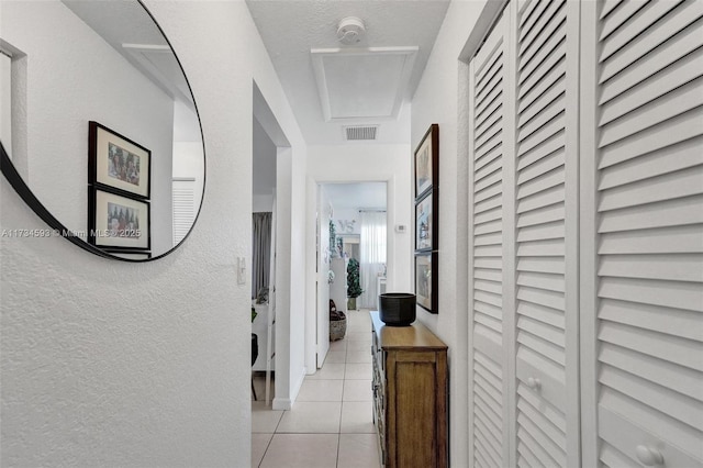 corridor with light tile patterned floors