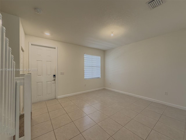 spare room with light tile patterned floors