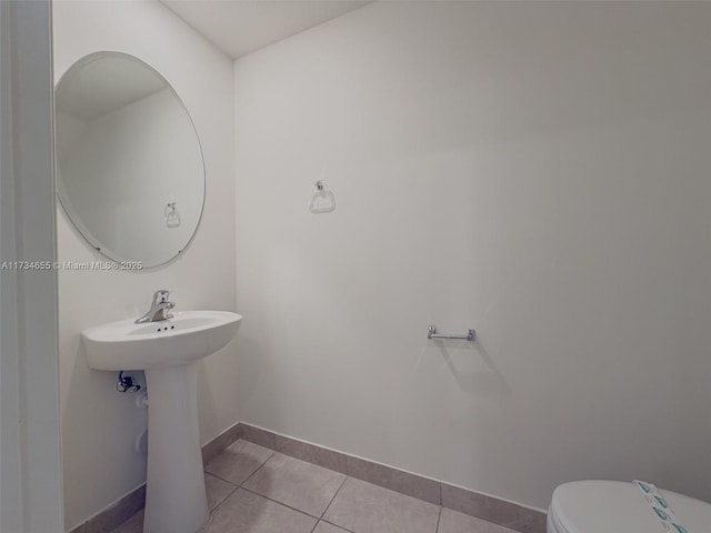 bathroom featuring tile patterned floors and toilet