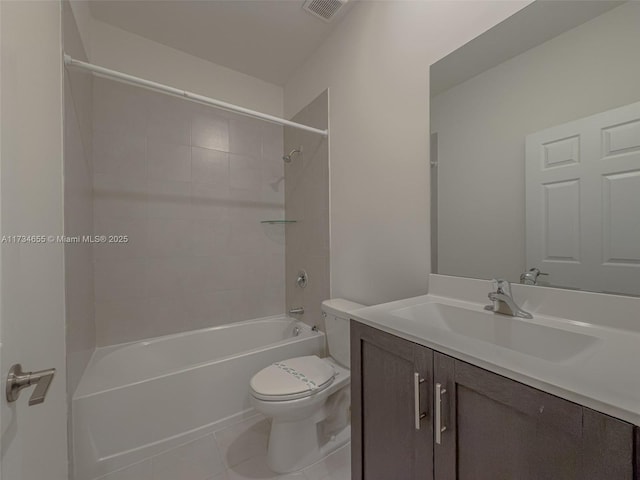 full bathroom with tile patterned flooring, vanity, tiled shower / bath combo, and toilet