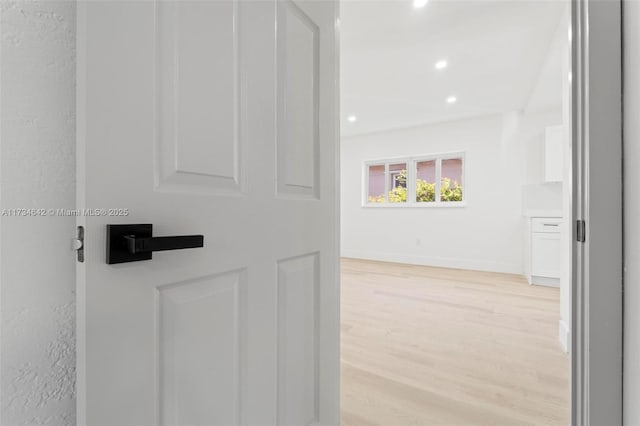 corridor with light hardwood / wood-style flooring