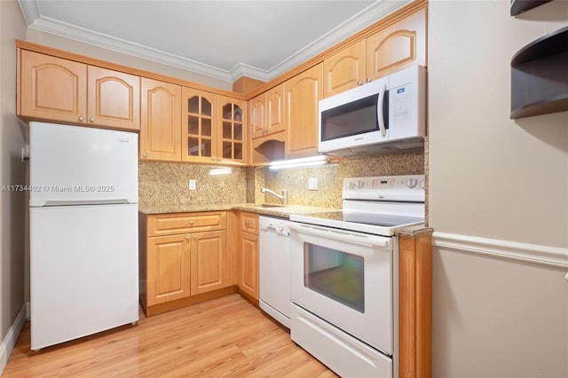 kitchen with crown molding, white appliances, and light brown cabinetry