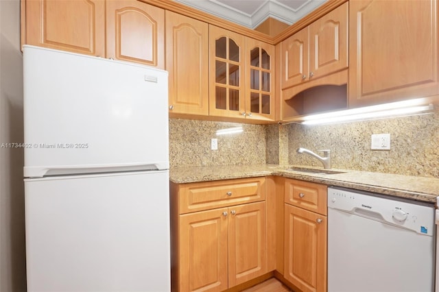 kitchen featuring sink, decorative backsplash, light stone counters, crown molding, and white appliances