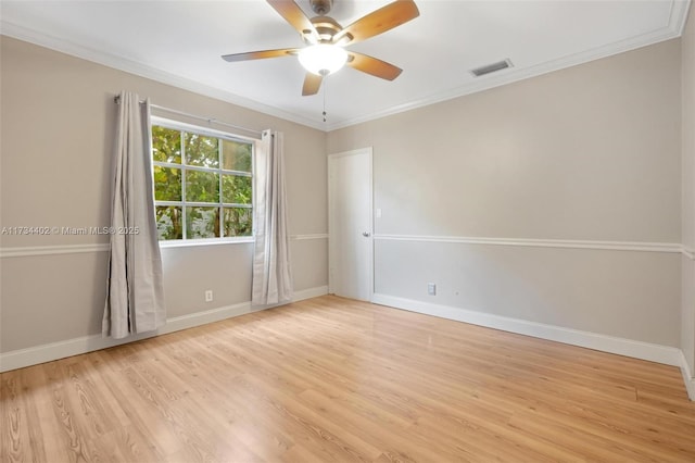 empty room featuring ornamental molding, ceiling fan, and light wood-type flooring