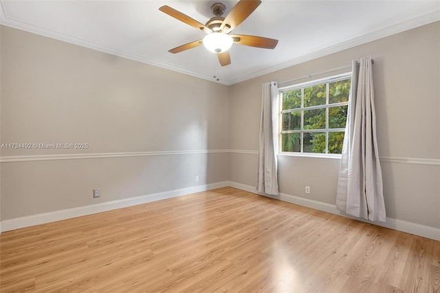 empty room featuring ornamental molding, ceiling fan, and light wood-type flooring