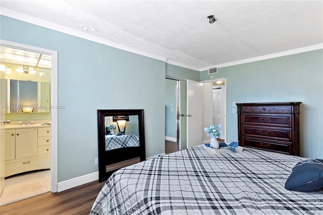 2851 Somerset Dr Unit 415, Lauderdale Lakes, FL 33311 - bedroom featuring wood finished floors, crown molding, baseboards, connected bathroom, and a textured ceiling