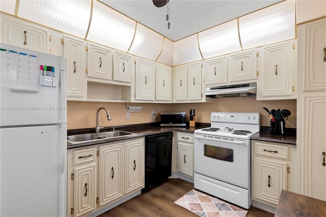 2851 Somerset Dr Unit 415, Lauderdale Lakes, FL 33311 - kitchen with white appliances, under cabinet range hood, dark countertops, a sink, and dark wood-style flooring