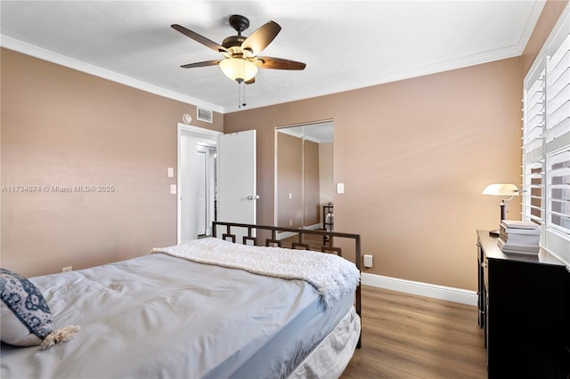 2851 Somerset Dr Unit 415, Lauderdale Lakes, FL 33311 - bedroom featuring wood finished floors, baseboards, ornamental molding, a ceiling fan, and multiple windows