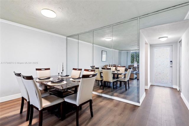 2851 Somerset Dr Unit 415, Lauderdale Lakes, FL 33311 - dining area with dark wood-style floors, baseboards, a textured ceiling, and ornamental molding