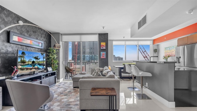 living room with plenty of natural light and floor to ceiling windows