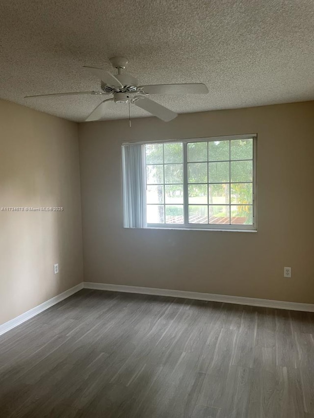 empty room with ceiling fan, hardwood / wood-style flooring, and a textured ceiling