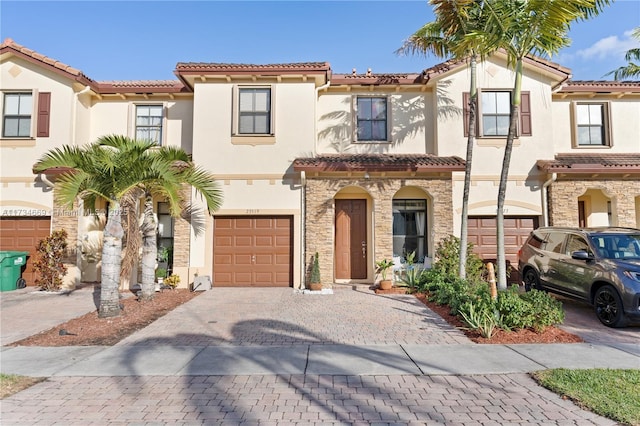 mediterranean / spanish-style house with a garage