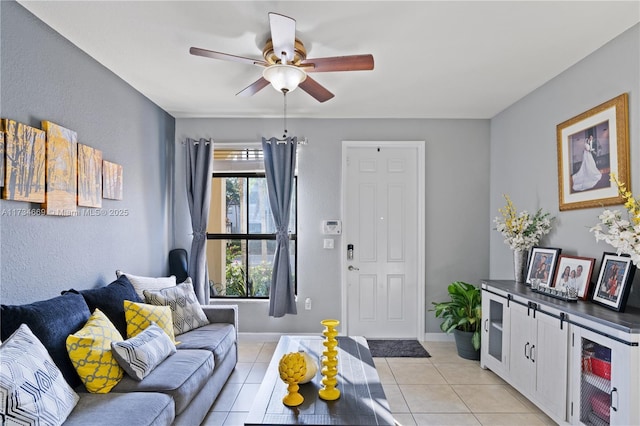 living room featuring light tile patterned floors and ceiling fan