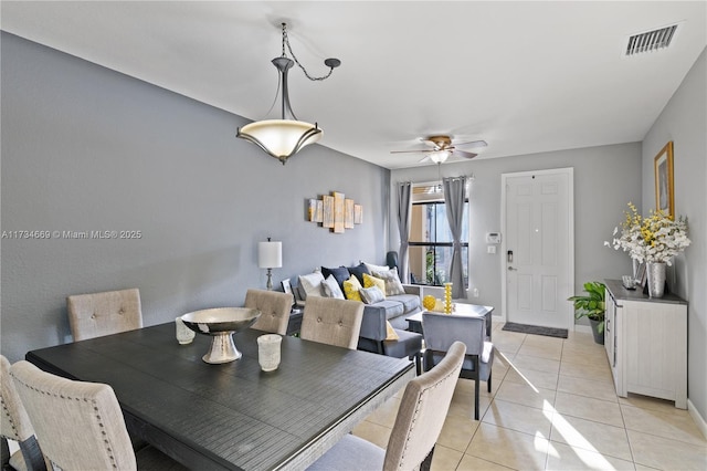 dining space with light tile patterned floors and ceiling fan