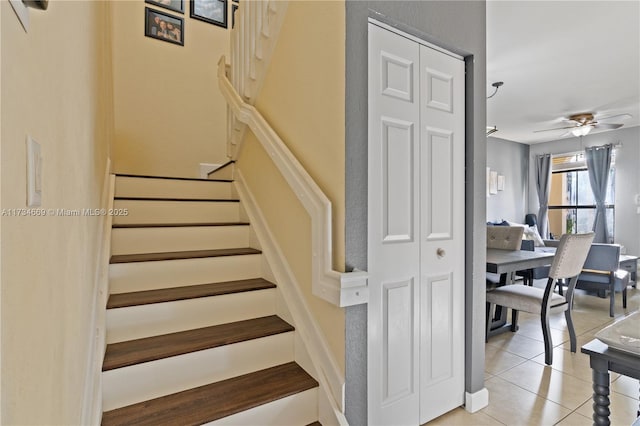 staircase with tile patterned flooring and ceiling fan