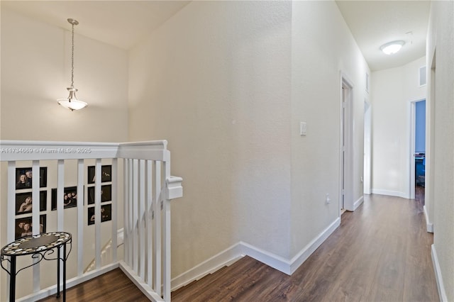 corridor with hardwood / wood-style floors