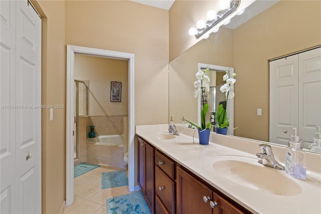 full bathroom with tile patterned flooring, vanity, separate shower and tub, and toilet