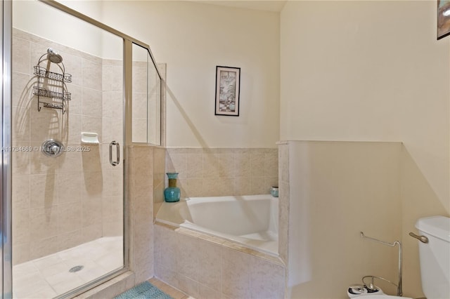 bathroom featuring toilet and shower with separate bathtub