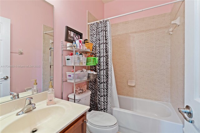 full bathroom featuring vanity, shower / bath combo, and toilet