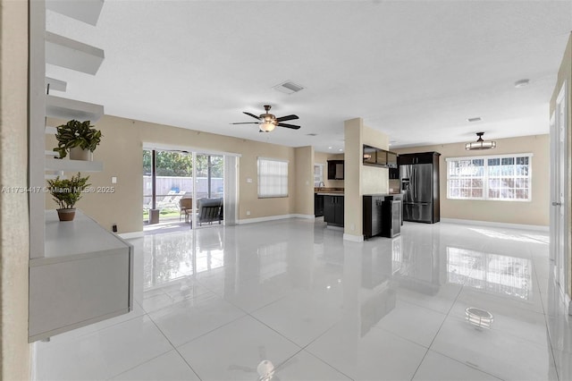 living room with ceiling fan and light tile patterned floors