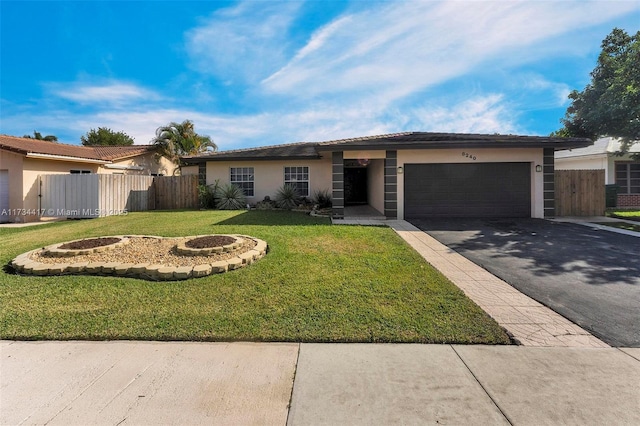 ranch-style home featuring a garage and a front yard